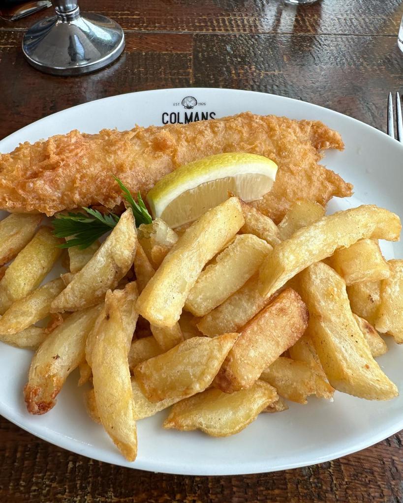 Fish and chips served with garnish and a lemon wedge at Colmans Seafood Temple, South Shields