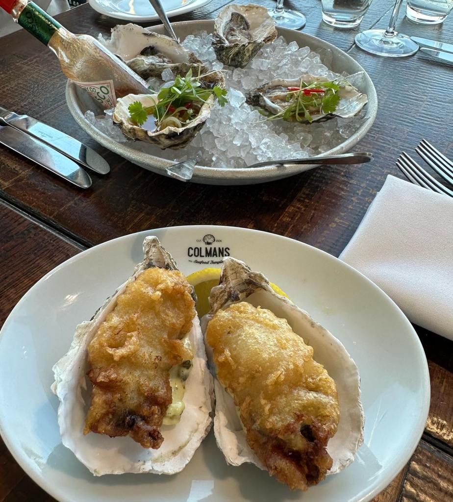 Fried Oysers served on tarter sauce in an oyster shell with a slice of lemon