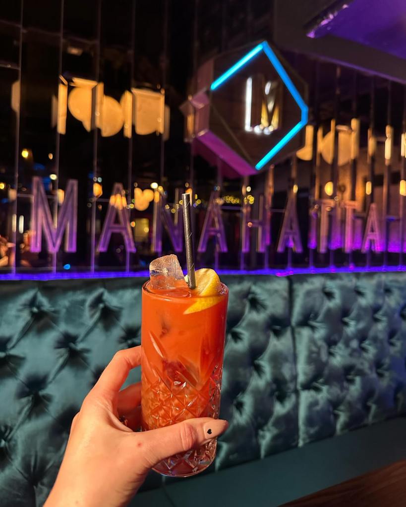 Bloody Mary at Manahatta, Newcastle with a backdrop of a velvet seating bench and classic manahatta sign