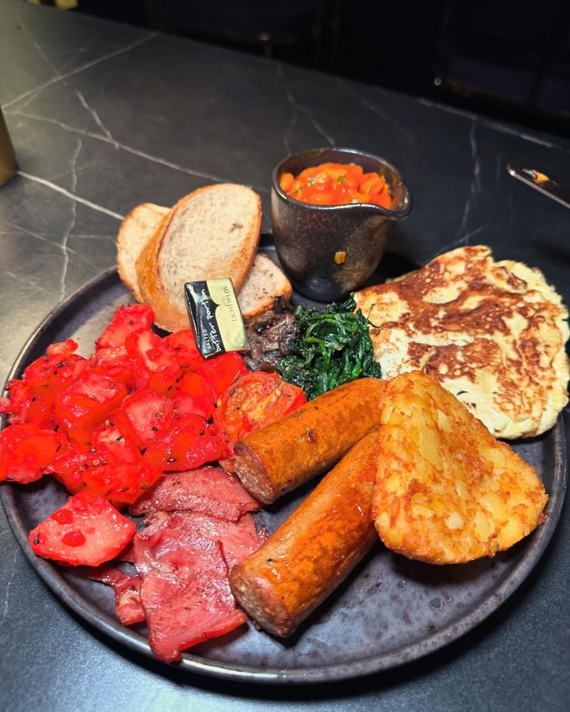 Desi-style breakfast plate with spicy sausage, Indian omelette, masala beans, and masala spiced potatoes.