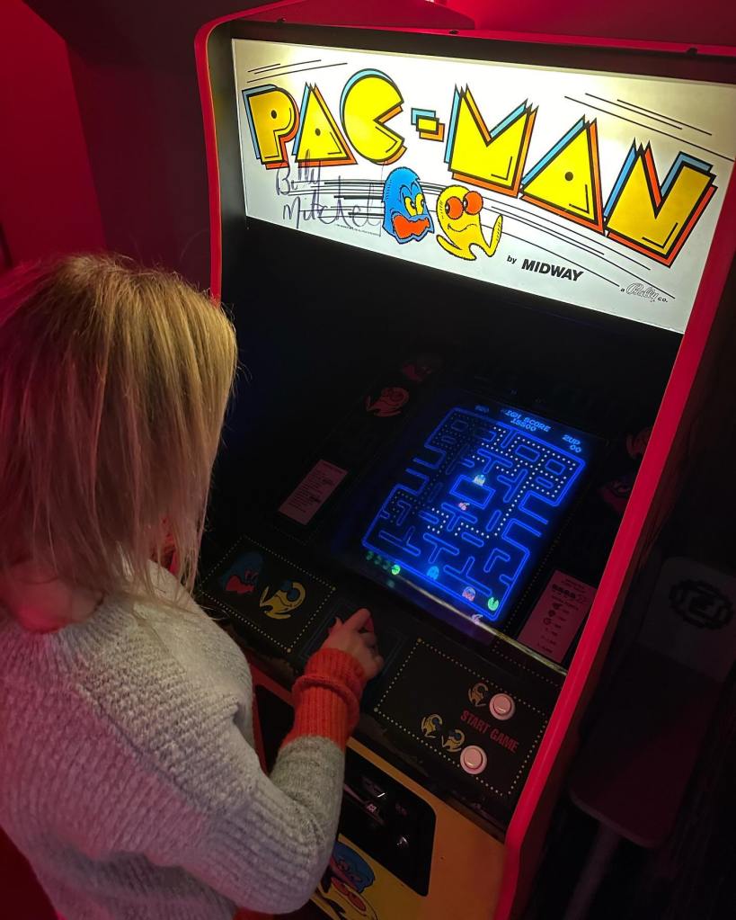 Classic arcade games at Four Quarters, including Space Invaders, Pac-Man, Mortal Kombat, and Sega Rally, providing a nostalgic gaming experience