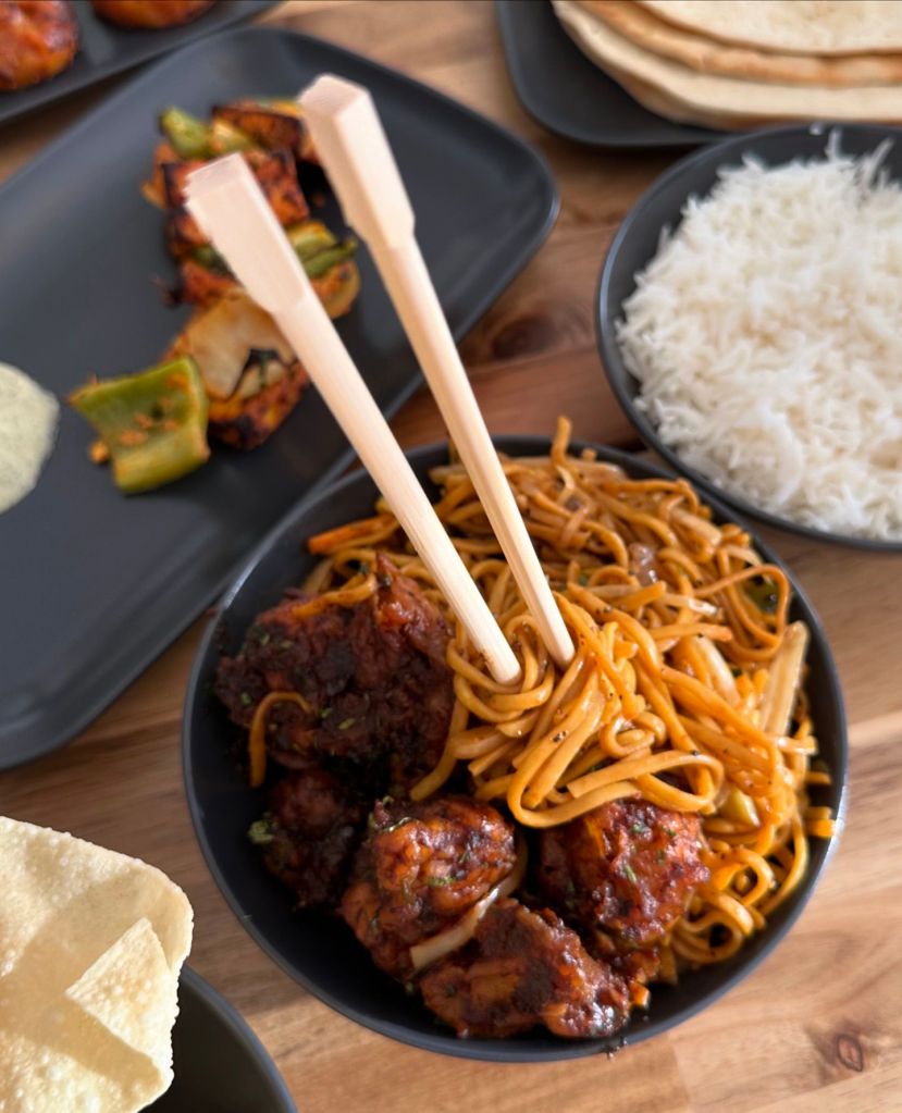 Firecracker cauliflower with noodles from Wok India, showcasing a stunning combination of flavors and textures