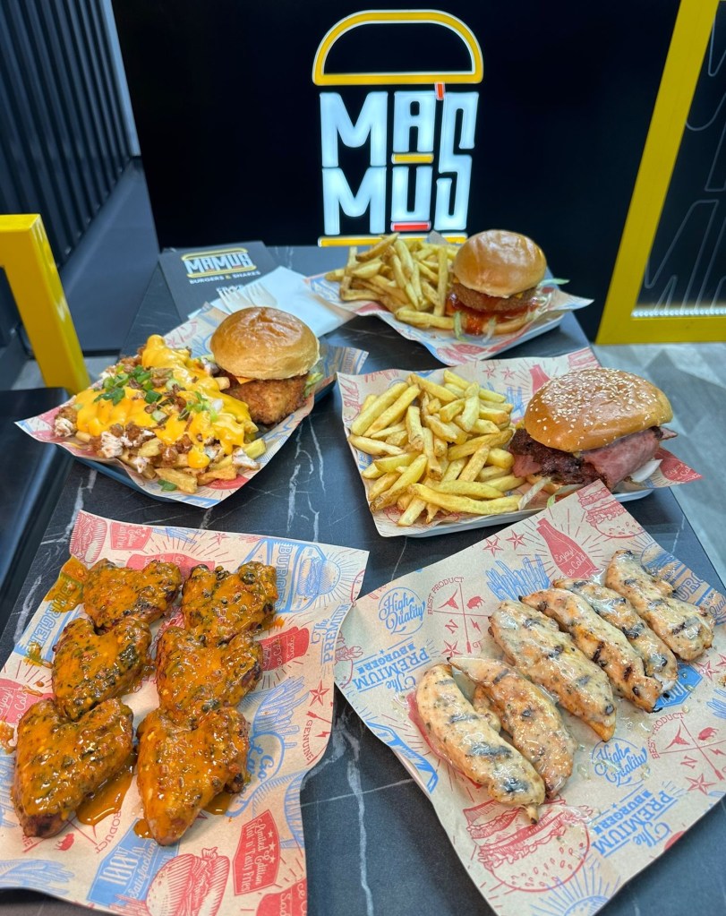 Veggilloumi Burger: A close-up of the Veggilloumi burger showcasing crispy halloumi and a juicy veggie patty in a soft bun. Blazing Chick Burger: The Blazing Chick burger with golden buttermilk fried chicken, garnished with spicy sauce. Rasher Smash Burger: The Rasher smash burger featuring crispy turkey bacon stacked on a juicy beef patty. Spicy Wings: A plate of fiery spicy wings with a tangy dipping sauce. Loaded Fries: A serving of loaded fries drizzled with rich sauce, topped with cheese and herbs.