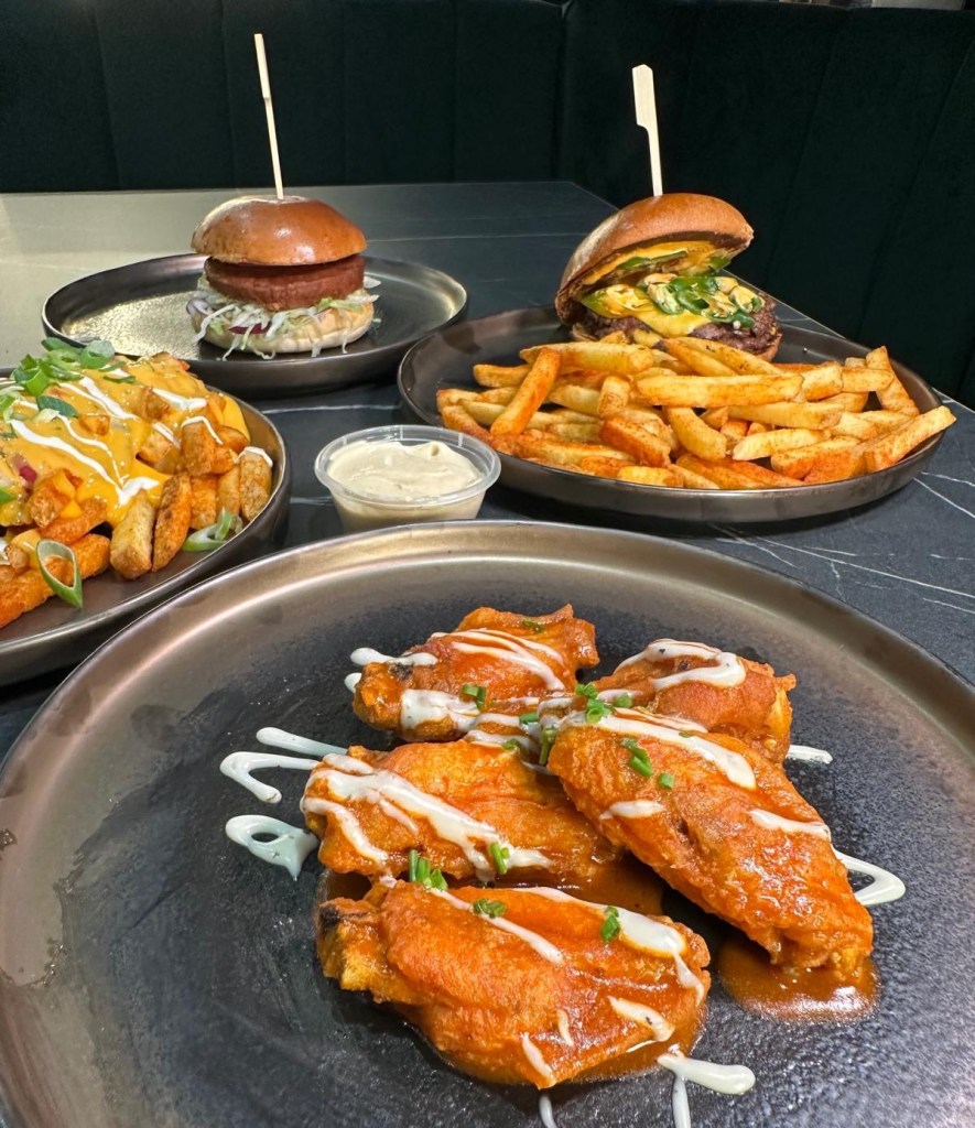 Crispy Fried Chicken Wing Pieces Crispy fried chicken wing pieces coated in a tangy Buffalo Ranch sauce, served on a platter with dipping sauce on the side