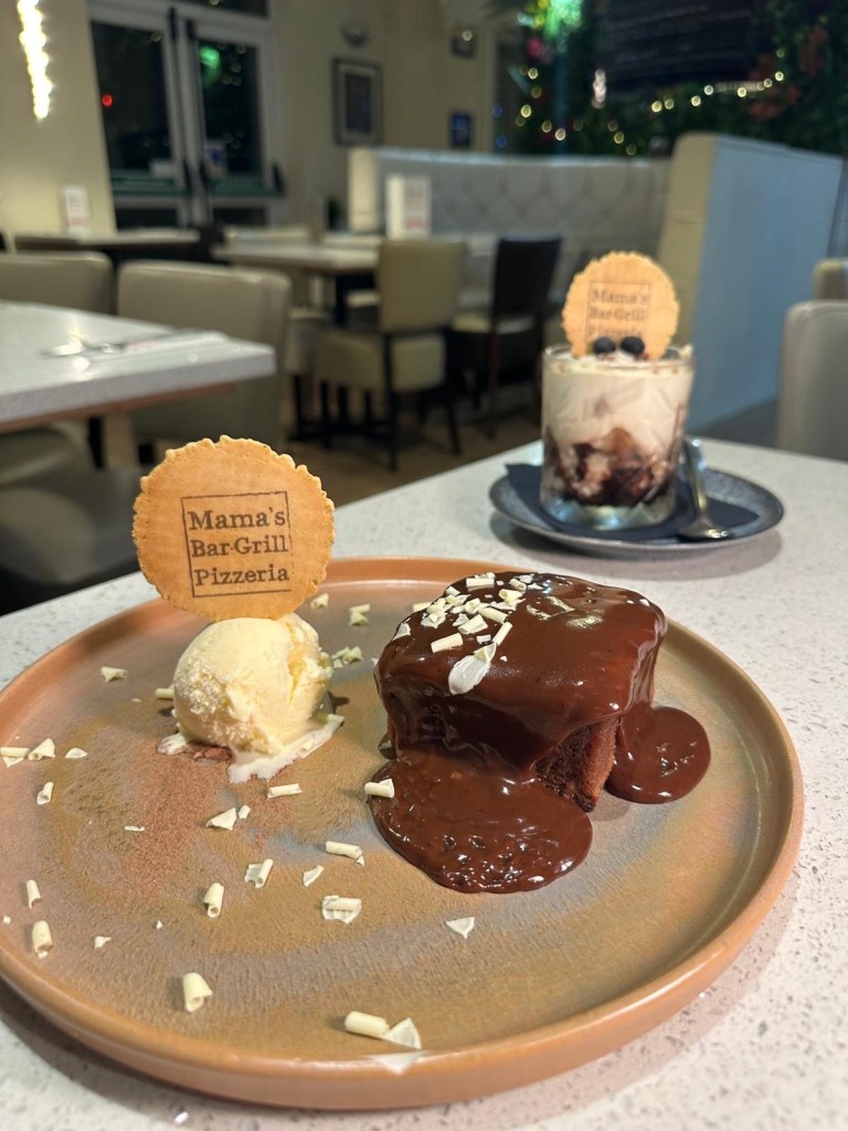 Brownie with Mars Bar sauce: Decadent homemade brownie with hot Mars Bar sauce and ice cream, a perfect autumn dessert at Mamas Bar and Grill