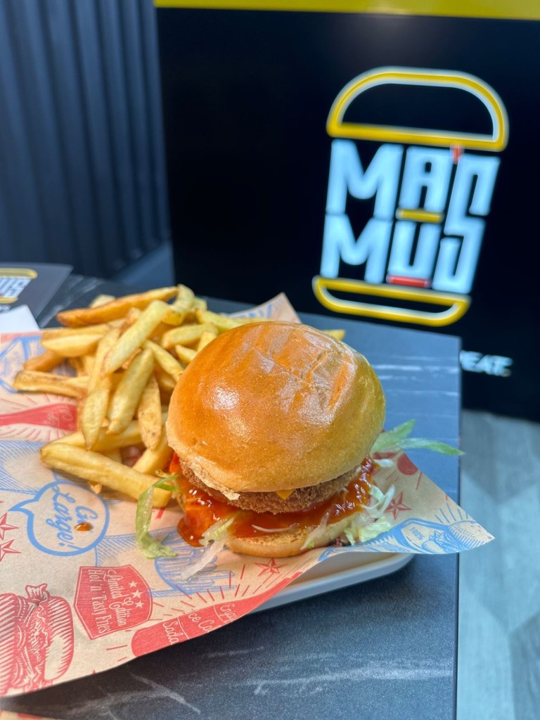 Veggilloumi Burger: A close-up of the Veggilloumi burger showcasing crispy halloumi and a juicy veggie patty in a soft bun