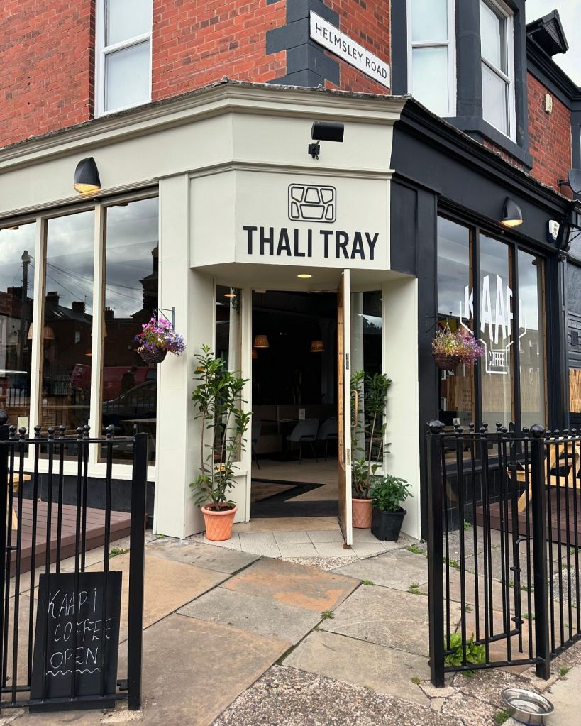 Modern and cozy decor at Thali Tray, featuring real plants and a relaxed atmosphere