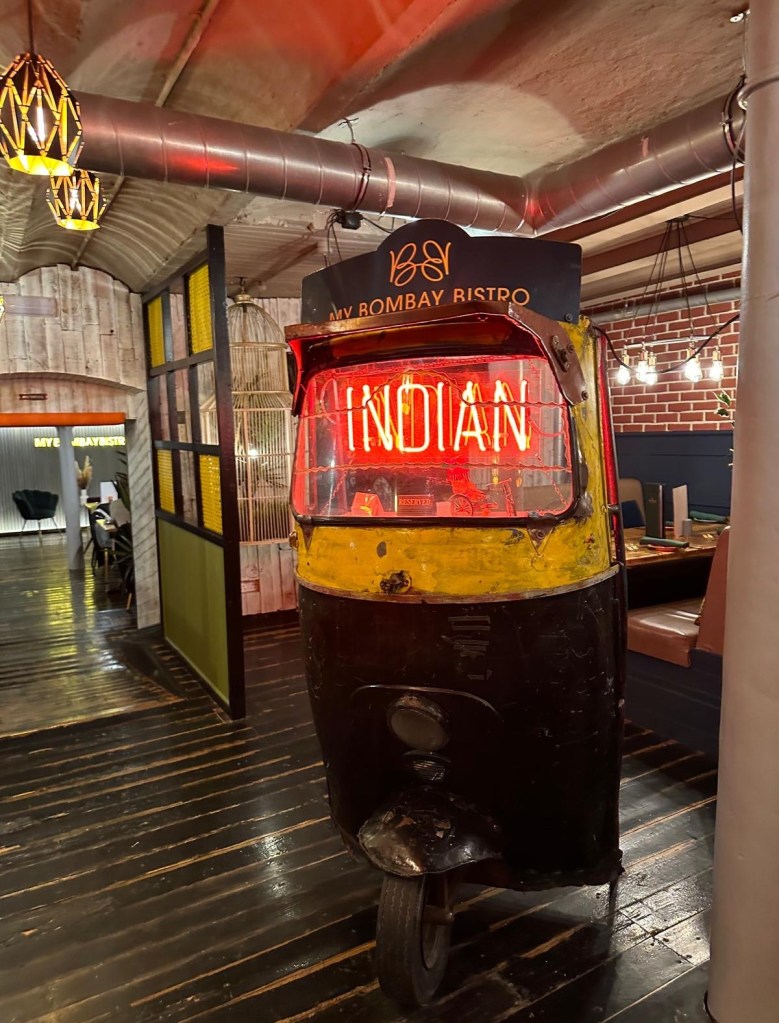 Colorful tuk-tuk decor at My Bombay Bistro in Sunderland, showcasing a blend of modern and traditional Indian aesthetics