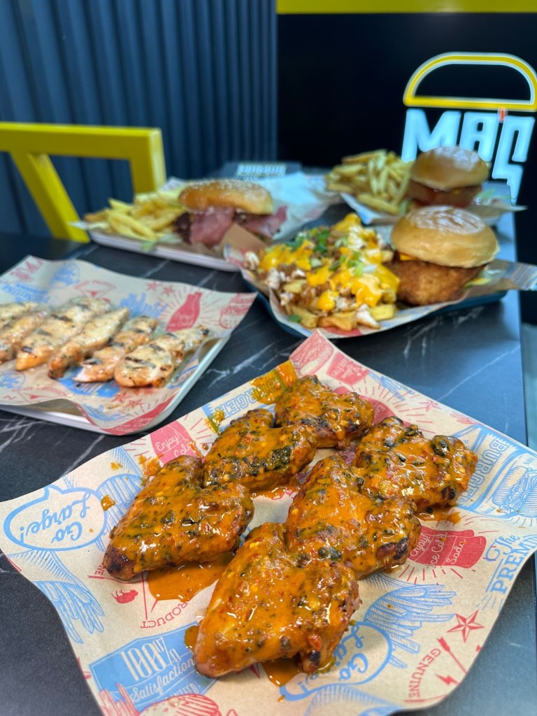 Veggilloumi Burger: A close-up of the Veggilloumi burger showcasing crispy halloumi and a juicy veggie patty in a soft bun. Blazing Chick Burger: The Blazing Chick burger with golden buttermilk fried chicken, garnished with spicy sauce. Rasher Smash Burger: The Rasher smash burger featuring crispy turkey bacon stacked on a juicy beef patty. Spicy Wings: A plate of fiery spicy wings with a tangy dipping sauce. Loaded Fries: A serving of loaded fries drizzled with rich sauce, topped with cheese and herbs.