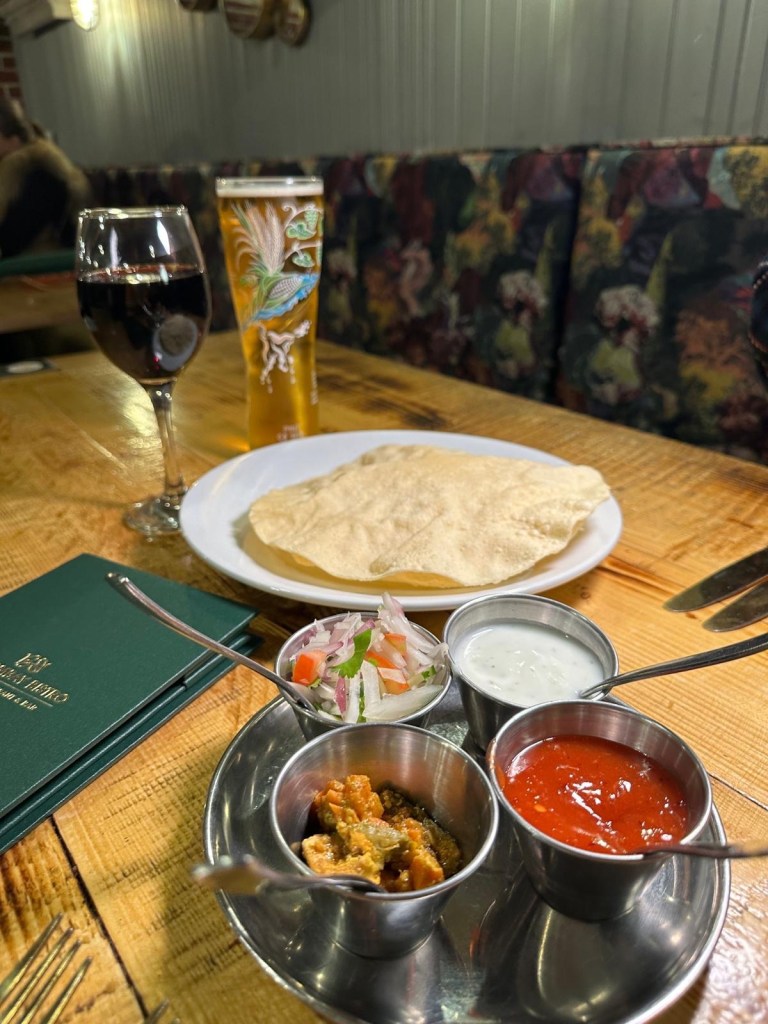 A selection of crispy popadoms served with assorted pickles and a spicy chili sauce at My Bombay Bistro