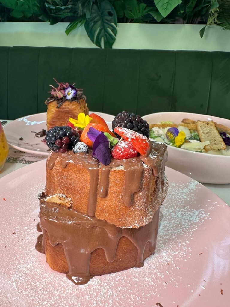 Nutella French Toast: A plate of thick, fluffy French toast topped with warm Nutella and mixed fresh berries, dusted with powdered sugar