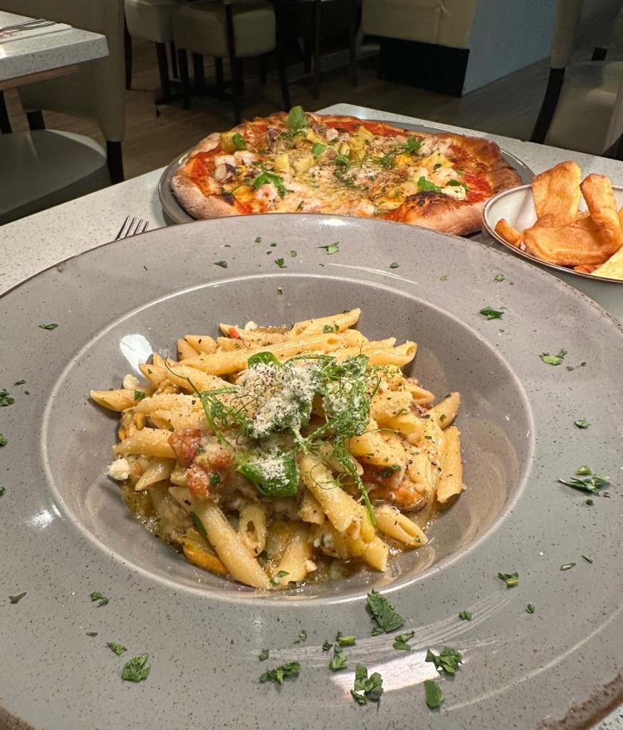 Frutti di Mare Pasta: Generously loaded Frutti di Mare Pasta with fresh seafood, including octopus Calamari mussel , and a hearty Italian main course Pizza Pescaro: Seafood pizza topped with perfectly cooked seafood and a hint of spice at Mamas Bar and Grill, ideal for seafood lovers