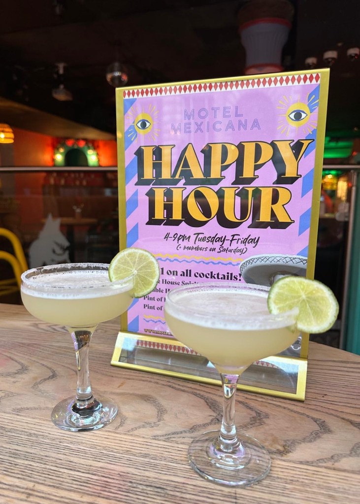 Signature Drinks: Refreshing margaritas and cocktails with tropical garnishes, capturing the lively essence of Motel Mexicana’s bar.