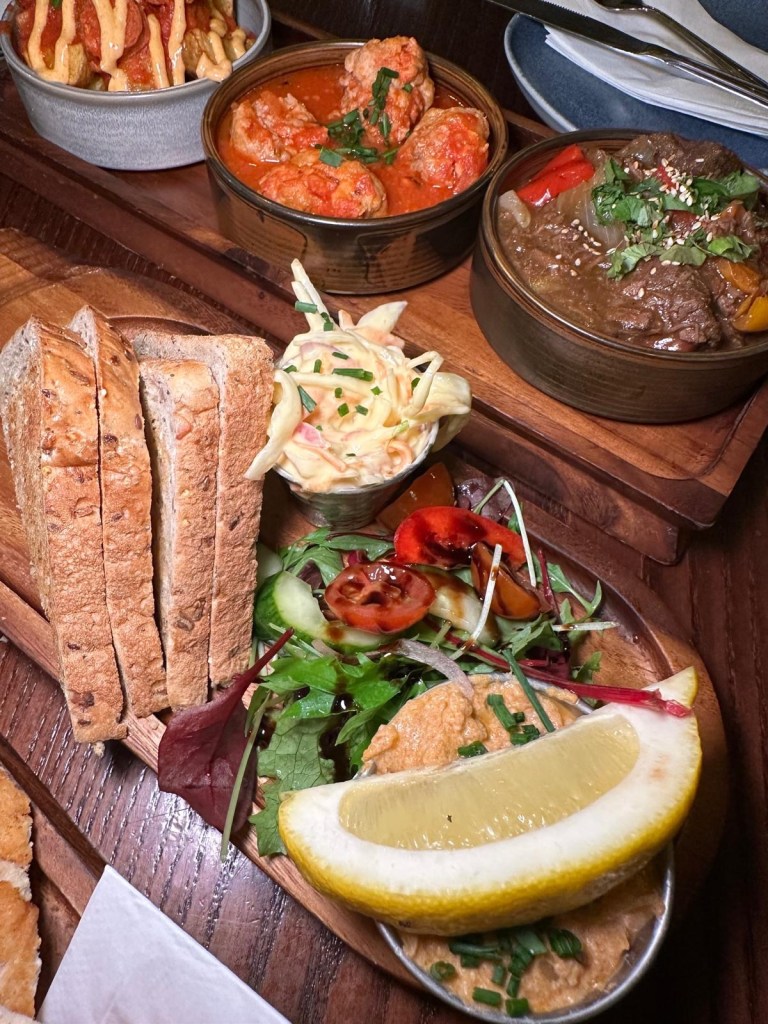North Shields Potted Crab at The Spread Eagle, North Shields: Close-up of Spread Eagle's North Shields Potted Crab served with warm brown toast, garden salad, and creamy coleslaw on a rustic plate