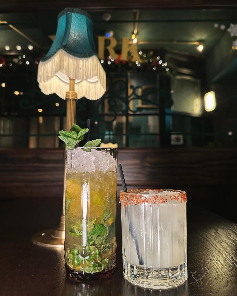 Close-up of Tickets' signature spiced margarita with a smoky, spicy rim served in a salt-rimmed glass, Refreshing watermelon mojito at Tickets bar, garnished with mint and lime for a fruity twist