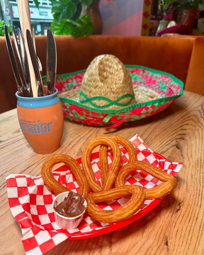 Churros: Crispy churros dusted in sugar, served with a side of rich chocolate dipping sauce.