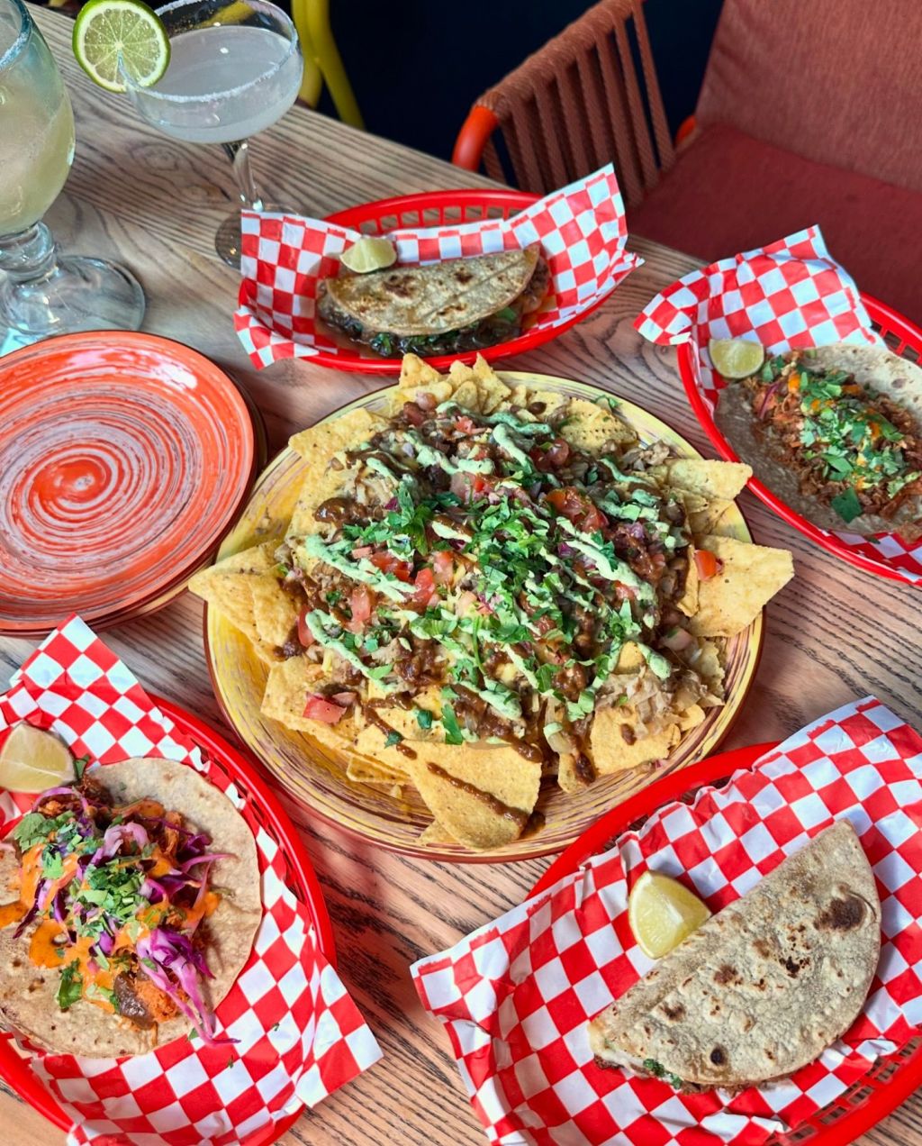 Loaded Nachos: A plate of loaded nachos piled high with melted cheese, fresh salsa, jalapeños, and guacamole. Tacos: Close-up of assorted tacos filled with flavorful ingredients like seasoned meats, fresh vegetables, and zesty sauces.