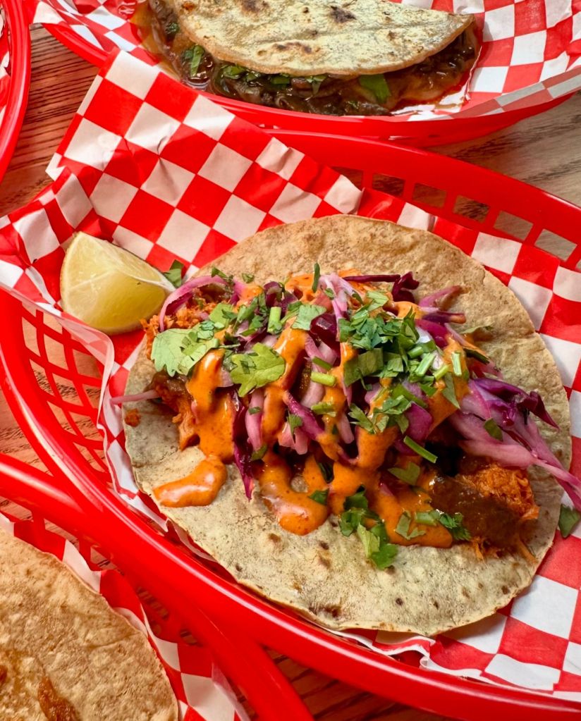 Tacos: Close-up of assorted tacos filled with flavorful ingredients like seasoned meats, fresh vegetables, and zesty sauces.
