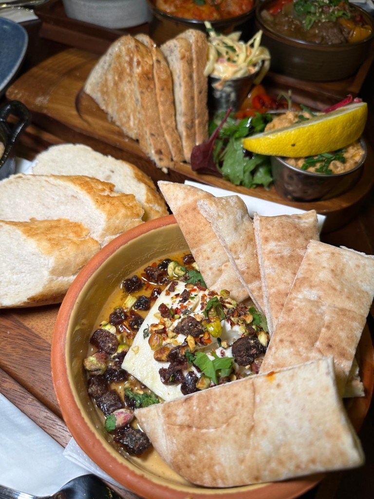 Chef’s Baked Feta at spread eagle, North Shields: Spread Eagle’s Baked Feta topped with honey, dates, and crunchy pistachios, accompanied by warm pita bread for a perfect dip