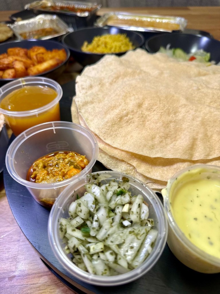 Thin, crispy popadoms served with fresh onion salad and a variety of condiments for sharing