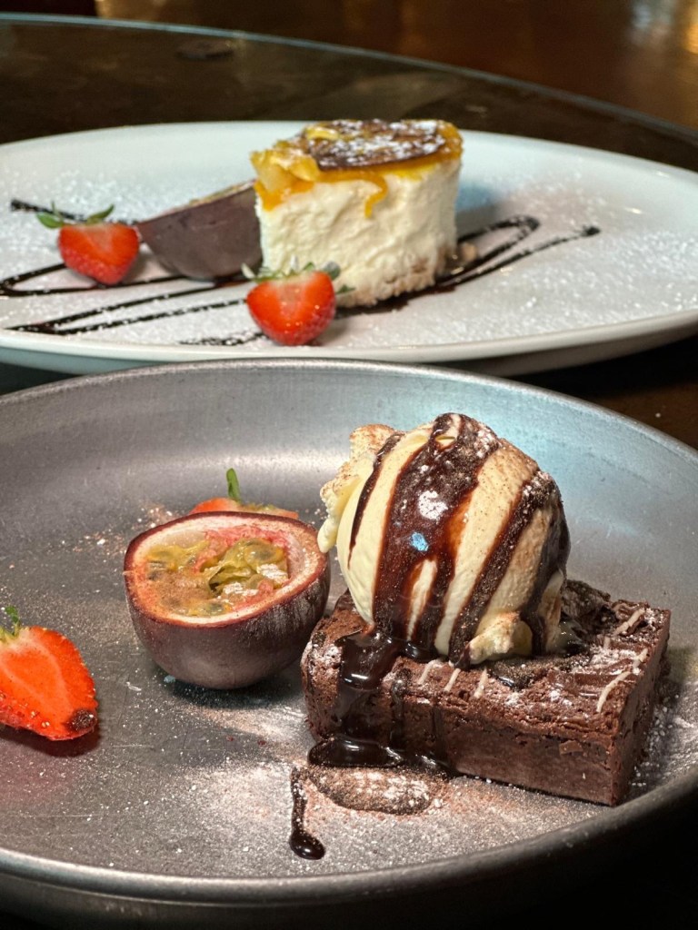 Mango & Passion fruit Iced Cheesecake (£4.99): A light and tropical iced cheesecake bursting with mango and passionfruit flavors, plated with a decorative garnish. Chocolate Brownie & Ice Cream (£4.99): A rich and fudgy chocolate brownie topped with a scoop of creamy ice cream, served warm for a delightful contrast
