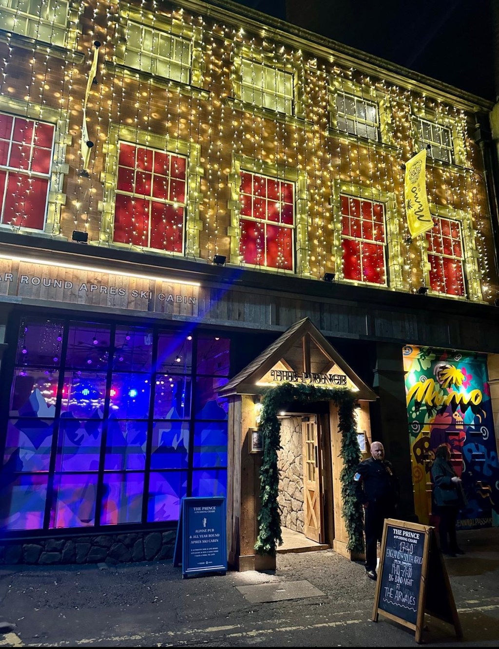 festive vibe of an exterior bar in Newcastle. The entrance has pine needle garland around it and hundreds of curtain lights cascading down the walls providing a warm and festive feel.