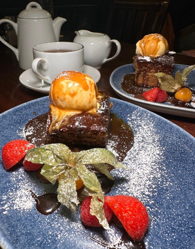 Sticky Toffee Pudding at The Spread Eagle, North Shields: Warm, date-filled Sticky Toffee Pudding topped with a scoop of ice cream and fresh fruit for a comforting, sweet finish.