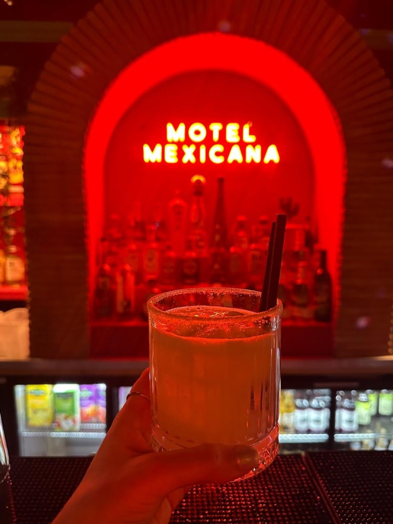 Restaurant Decor: Vibrant Latin-inspired interior of Motel Mexicana in Newcastle, featuring colorful murals, neon signs, and festive lighting.