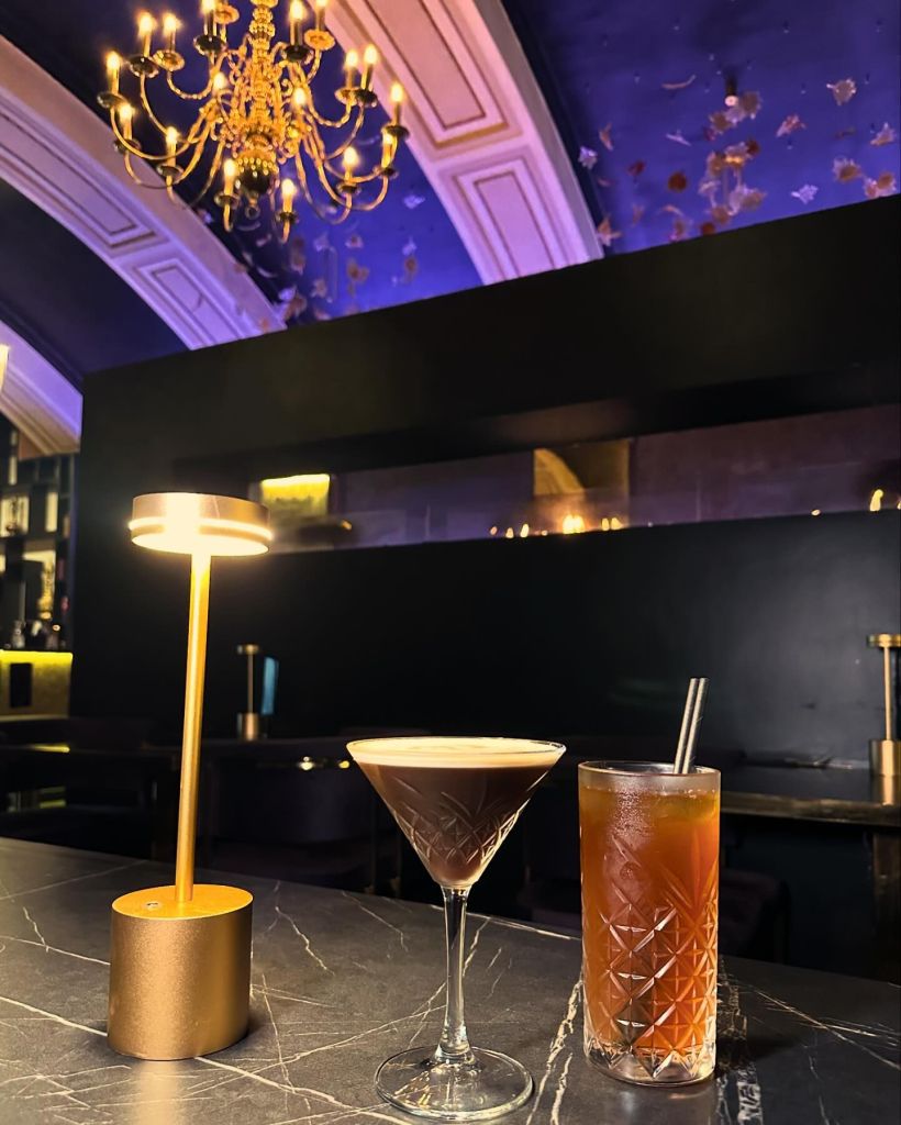 Espresso martini mocktail served in a sleek glass, topped with foam and garnished with coffee beans. Refreshing iced tea served in a tall glass with ice cubes, lemon slices, and a sprig of mint.