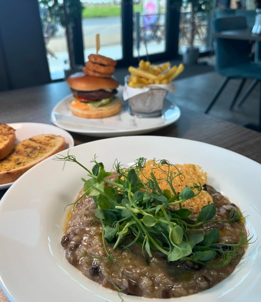 A beautifully plated wild mushroom risotto at Breeze Lounge, garnished with parmesan and drizzled with truffle oil