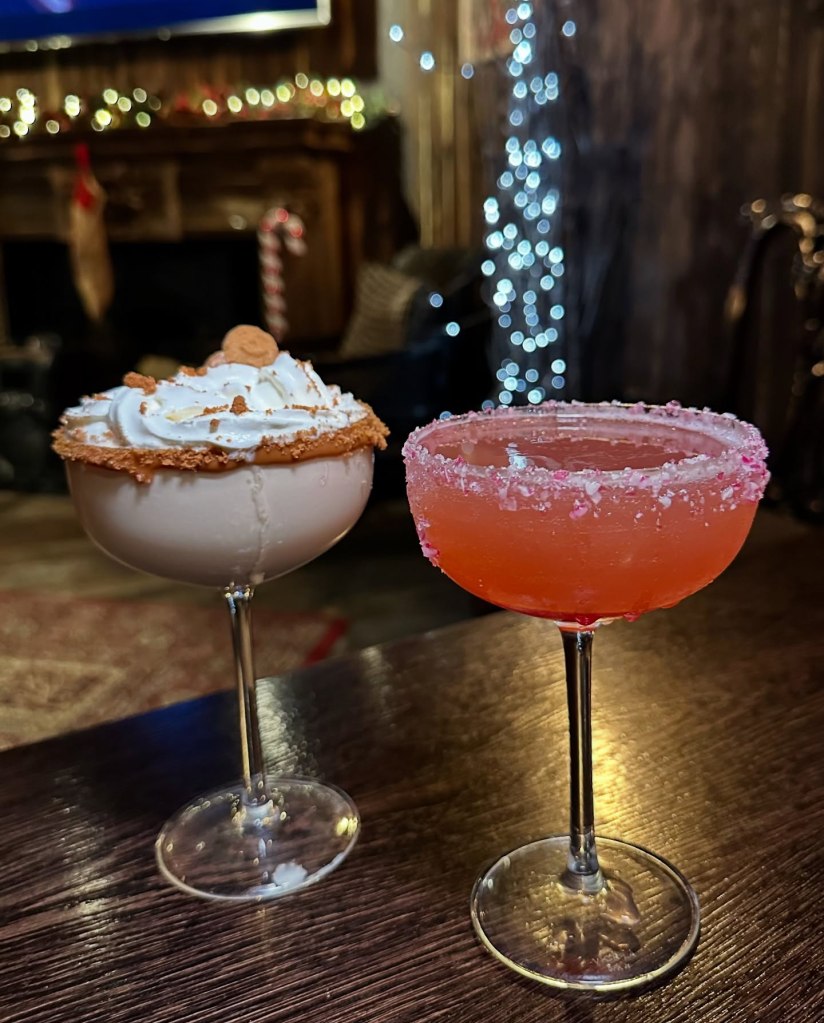 Festive Gingerbread Man cocktail at Sticky Wicket, topped with Lotus Biscoff, whipped cream, and a sprinkle of cinnamon,. Santa Cosmopolitan cocktail served at Sticky Wicket, garnished with candy canes and featuring cranberry juice for a Christmassy twist