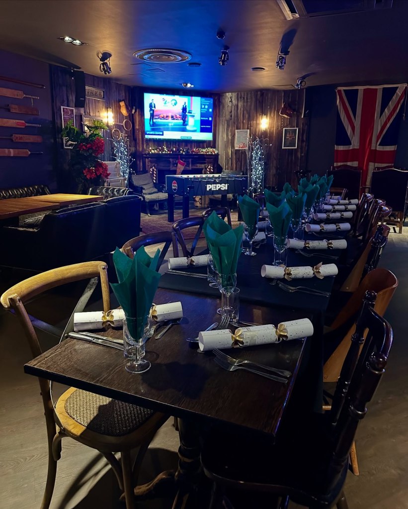 Cozy interior of Sticky Wicket pub, featuring rustic wooden tables, warm lighting, and a welcoming atmosphere for dog-friendly dining