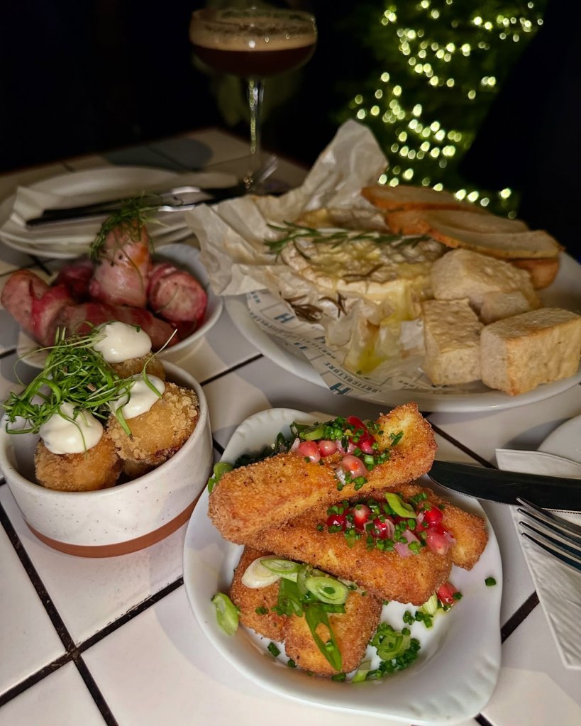 Assortment of small plates at Horticulture Newcastle, including Brie & cranberry bites, halloumi fries, baked Camembert, and pigs in blankets.