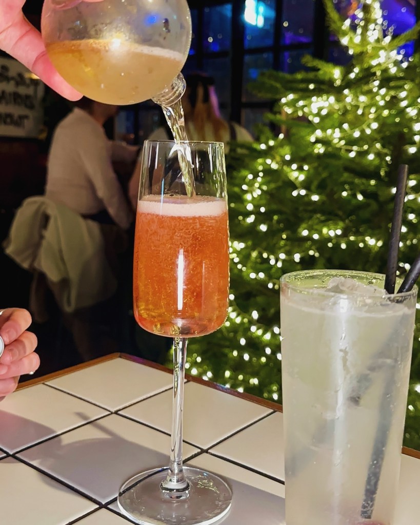 Tinsel Royale cocktail with Chambord, prosecco, and glitter at Horticulture
