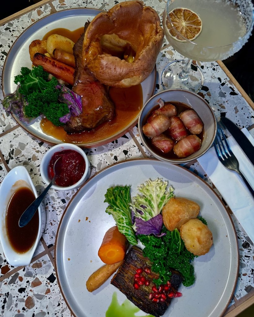 Roast sirloin of beef with mashed potatoes, roasties, Yorkshire pudding, and gravy at Horticulture. Caramelised celeriac & mushroom gratin with pomegranate and vegan feta at Horticulture