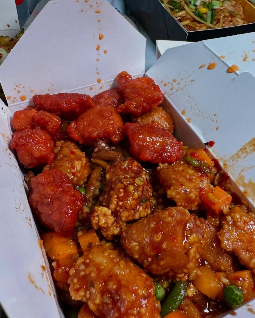Udon noodles with sweet & sour chicken and fiery garlic chicken at Oodles Wok.