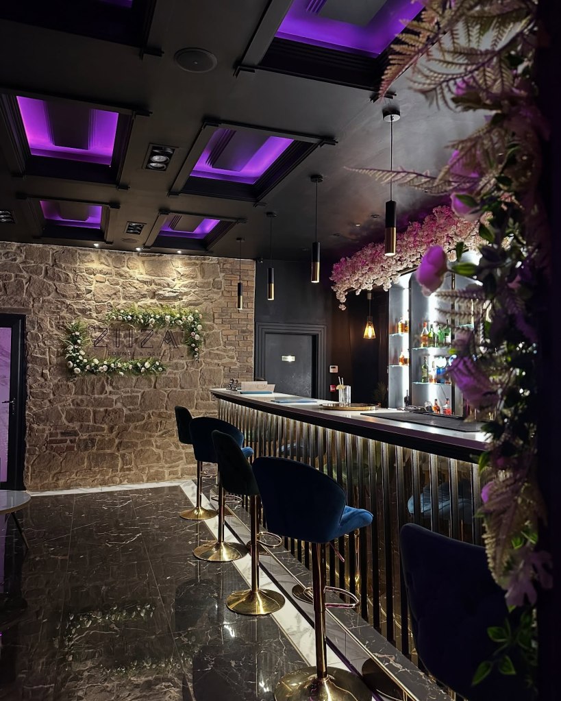 Beautifully decorated interior of Ziiza Lounge and Grill with modern, cozy seating.