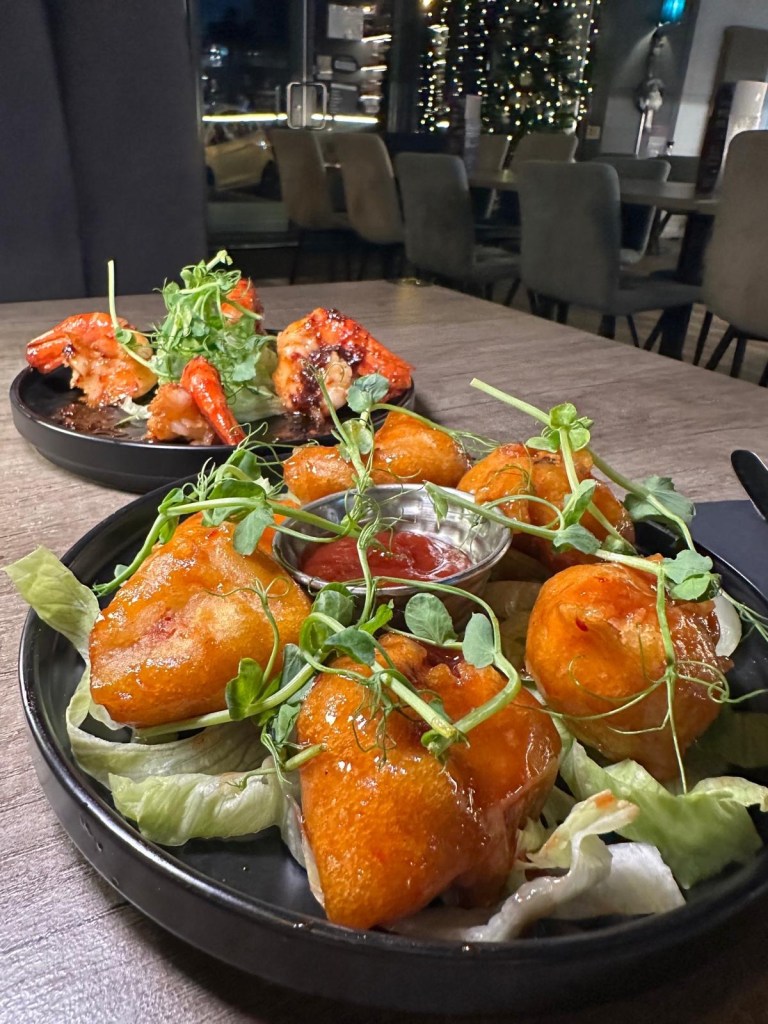 Sticky chicken served with sweet BBQ sauce and a side of chilli jam at Breeze Lounge