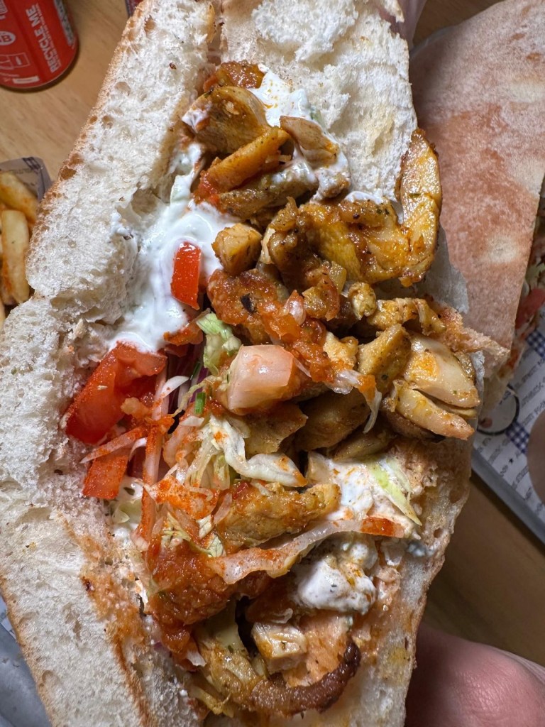 A Geordie Gyros featuring tender grilled chicken or halloumi, crisp salad, and Acropolis’ signature sauce, all wrapped in a soft, floury stottie.
