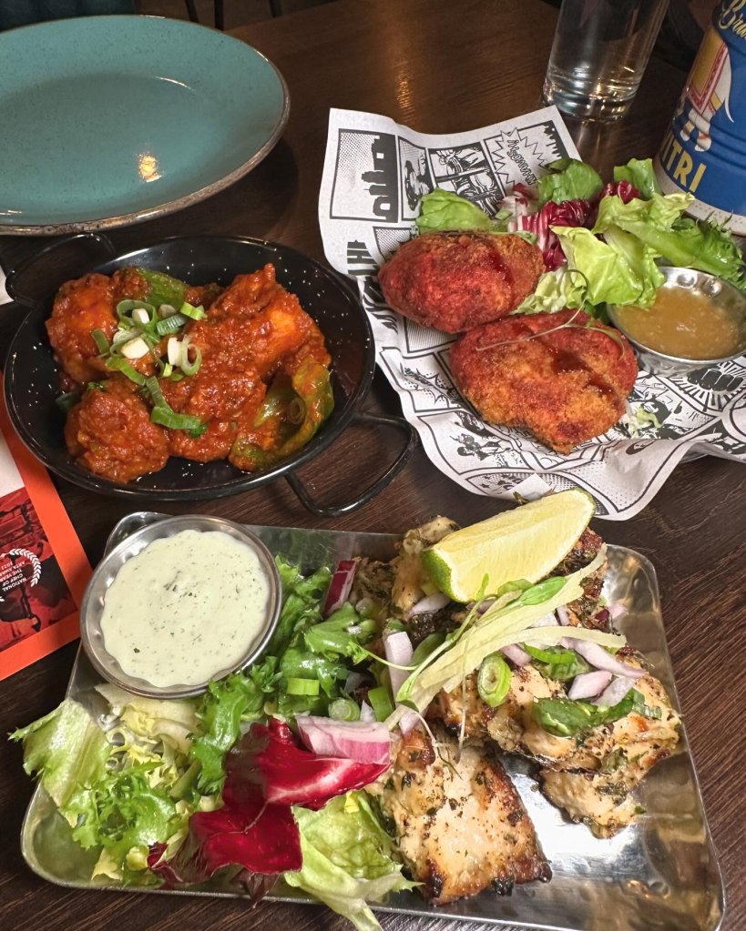 Firecracker Paneer, with soft paneer cubes in a vibrant, spicy sauce, garnished with herbs