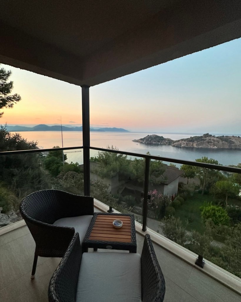 Modern sea-view room at TUI Blue Seno with a private balcony overlooking the turquoise coast, featuring elegant decor and a luxurious rainfall shower