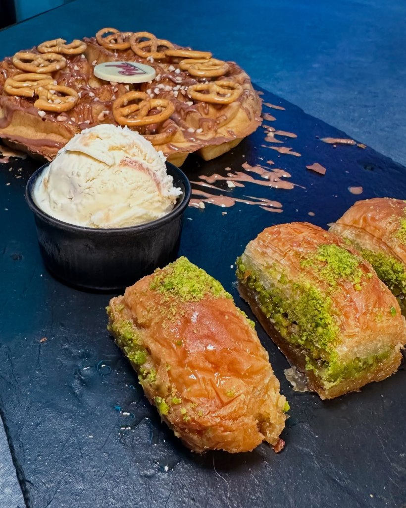 Rich pistachio baklava with layers of golden filo pastry and a nutty filling, drizzled with syrup
