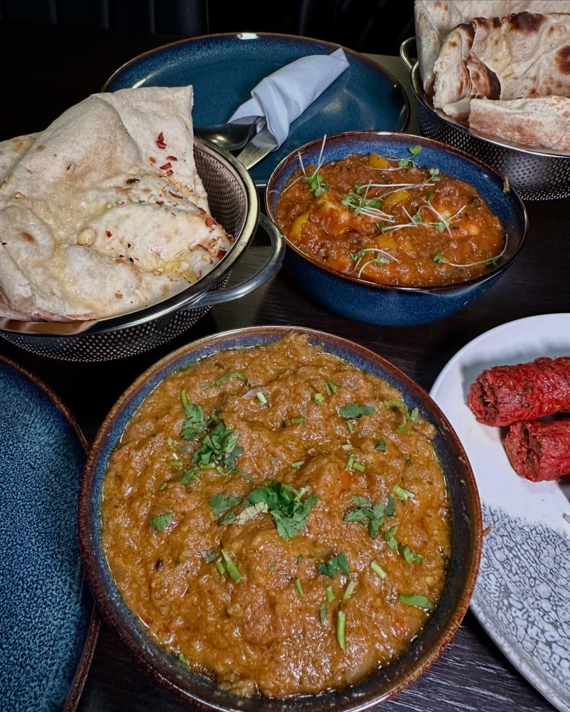 Sanskrit's Signature Curry with tender lamb pieces, caramelized onions, and a rich, spiced tomato sauce
