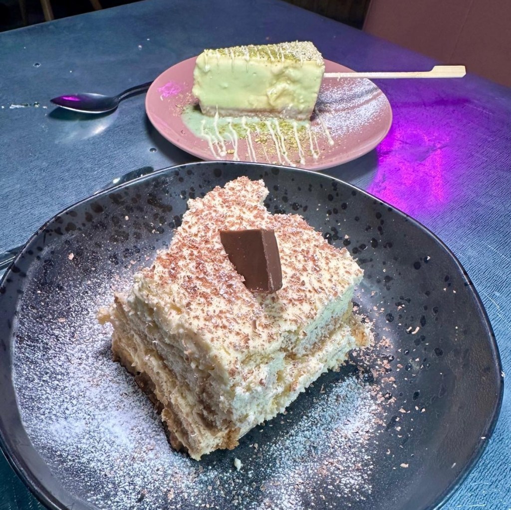 Dessert spread at Circo Italian featuring tiramisu and pistachio cheesecake