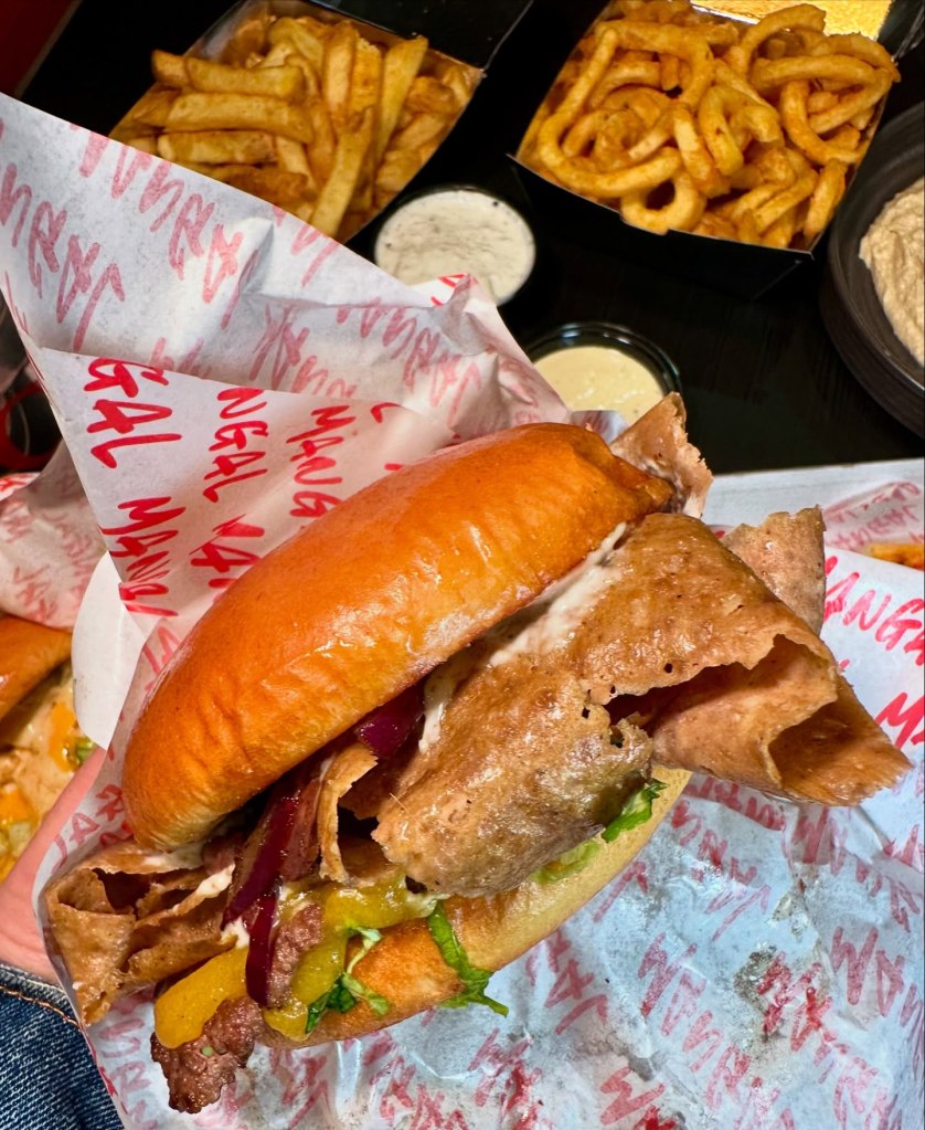 A juicy beef patty topped with caramelized onions, fresh lettuce, and Mangal’s signature smoky-sweet sauce, served in a soft toasted bun.