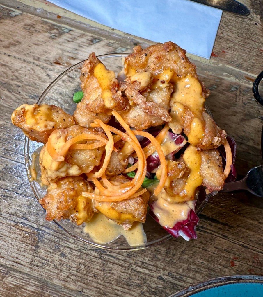 Dynamite Chicken bites, crispy and fiery, coated in a rich red sauce with a hint of sweetness