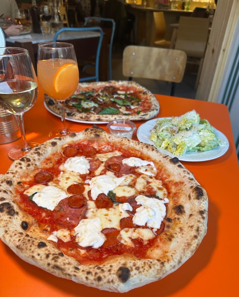 A hearty Neapolitan pizza loaded with salame finocchiona, salame piccante, and wild boar salame on a tomato base with melted mozzarella