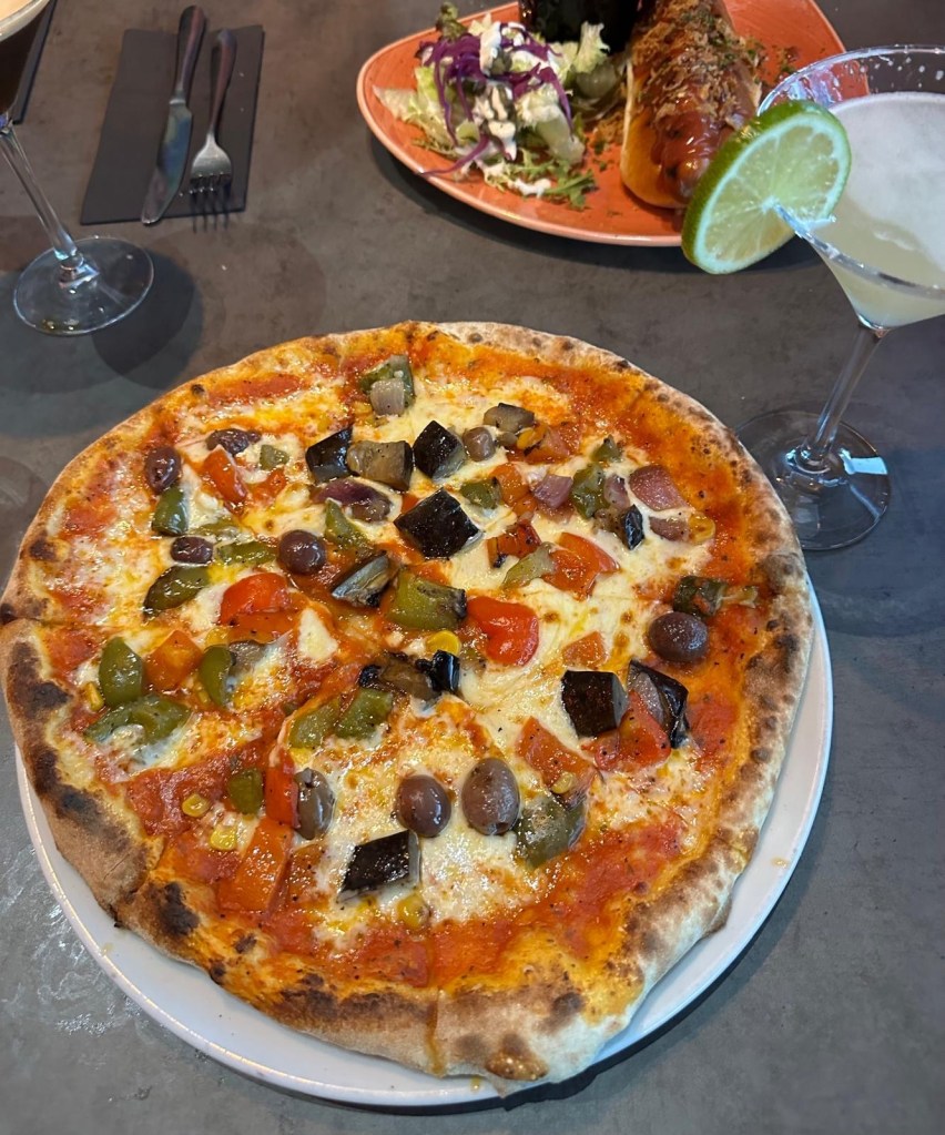 Delicious pizza with a crispy crust, fresh toppings, and melted cheese at Geisha Fusion