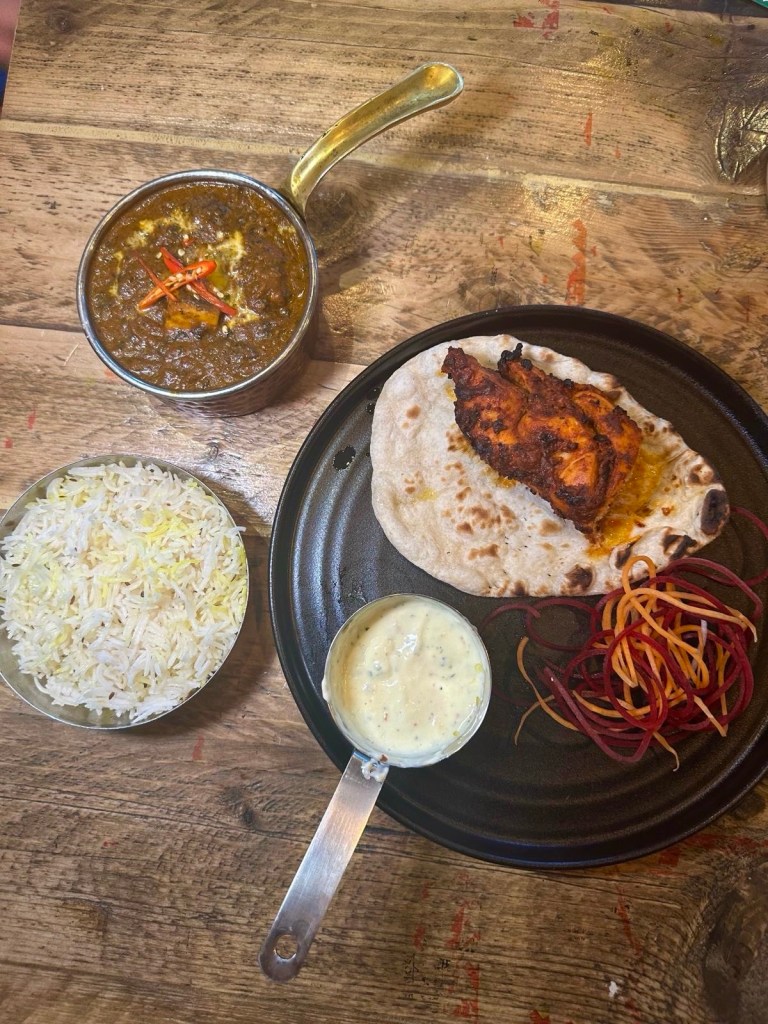Aslam Smoked Tandoori Chicken and Dum Pulao Rice served under a cloche, releasing smoke upon opening