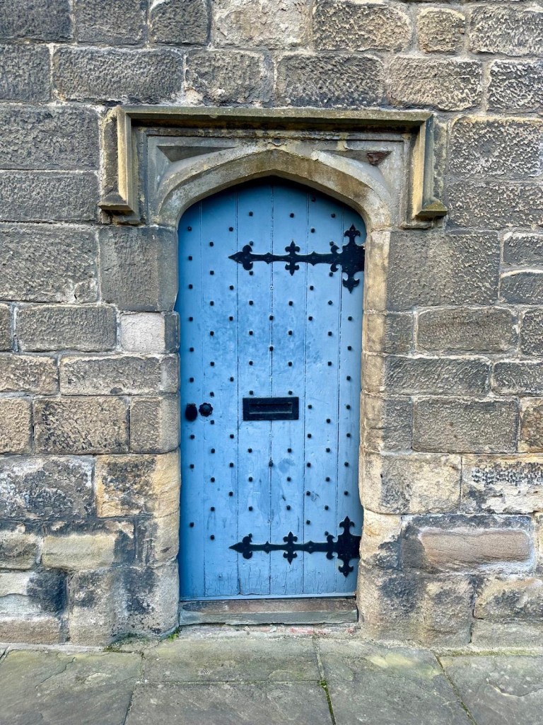 Historic wooden door at Blackfriars Newcastle, framed by ancient stone walls